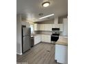 Modern kitchen with stainless steel appliances, white cabinetry, and a skylight at 8427 W Glendale Ave # 31, Glendale, AZ 85305