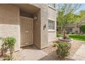 Cozy entryway with desert landscaping, security door and water feature at 10017 E Mountain View Road -- # 1045, Scottsdale, AZ 85258