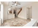 Open-concept living space featuring tile floors and a staircase at 10017 E Mountain View Road -- # 1045, Scottsdale, AZ 85258