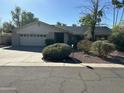 Charming single-story home with a well-maintained front yard and a two-car garage at 10249 N 58Th Pl, Paradise Valley, AZ 85253