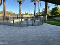 Backyard swimming pool surrounded by a stone patio and privacy fencing at 10249 N 58Th Pl, Paradise Valley, AZ 85253