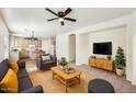 Inviting living room with stylish furniture, ceiling fan, and open-concept design at 11564 W Harrison St, Avondale, AZ 85323