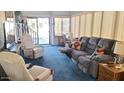 Bright living room featuring comfortable seating and sliding door access at 1284 S Sioux Dr # 1284, Apache Junction, AZ 85119