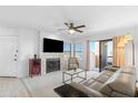 Bright living room featuring a tile fireplace, ceiling fan, sliding glass doors to balcony, and comfortable seating at 14645 N Fountain Hills N Blvd # 215, Fountain Hills, AZ 85268