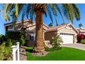 Angle view of the home, showing off the well maintained front yard and desert landscaping at 15460 W Merrell St, Goodyear, AZ 85395