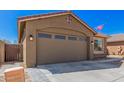 Single-Gathering home featuring a two-car garage with beautiful desert landscaping at 16573 W Alameda Rd, Surprise, AZ 85387
