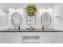 Elegant bathroom with double sinks, stylish mirrors, and ample storage space, offering a clean and functional design at 187 E Santa Lucia Ln, Queen Creek, AZ 85140