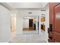 Bright hallway featuring light wood-look tile flooring, with mirrored closet, connecting living spaces at 18811 N 19Th Ave # 3015, Phoenix, AZ 85027
