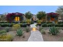 Charming single-story home features a stone walkway, lush landscaping, and flowering bougainvillea at 18916 N 98Th St # 3709, Scottsdale, AZ 85255