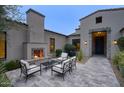 Cozy patio with an outdoor fireplace, comfortable seating, and brick-accented architecture at 18916 N 98Th St # 3709, Scottsdale, AZ 85255