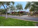 Street view of landscaped front yards featuring mature trees and colorful vegetation at 18916 N 98Th St # 3709, Scottsdale, AZ 85255