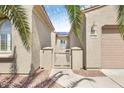 Light tan home featuring private courtyard with metal gate and desert landscaping at 21026 N Circle Cliffs Dr, Surprise, AZ 85387