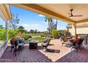 Relaxing covered patio with ample seating, bar area, and views of the lush golf course at 23108 N Pedregosa Dr, Sun City West, AZ 85375