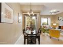Dining area leading to a living room and balcony with natural lighting at 3330 S Gilbert Rd # 2090, Chandler, AZ 85286