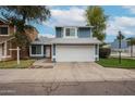 Charming two-story home with a blue exterior, white garage door, and manicured lawn at 3520 E Le Marche Ave, Phoenix, AZ 85032