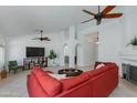 Spacious living room featuring tile floors, ceiling fans, and arched doorways at 3544 E Tonto Ln, Phoenix, AZ 85050