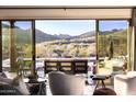 Inviting living room featuring a view of the desert landscape and outdoor lounge seating at 36190 N Creek View Ln, Cave Creek, AZ 85331