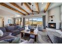 Open living area with high beamed ceilings, fireplace, and mountain views from the large windows at 36190 N Creek View Ln, Cave Creek, AZ 85331