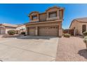 Charming two-story home featuring a three-car garage and desert landscaping at 3875 E Juanita Ave, Gilbert, AZ 85234