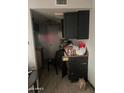 Functional kitchen space with dark cabinets and essential appliances at 3944 W Camelback Rd, Phoenix, AZ 85019