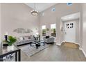 Bright, open living room featuring vaulted ceilings, a stylish grey sofa, and lots of natural light at 4013 N Founder Cir, Buckeye, AZ 85396