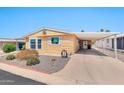Inviting single-story home featuring a covered carport and low-maintenance desert landscaping at 5402 E Mckellips Rd # 298, Mesa, AZ 85215