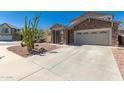 Attractive home with a long driveway and desert-style landscaping, presenting an appealing curb view at 5430 S 23Rd Way, Phoenix, AZ 85040