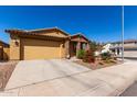 Charming single-story home showcasing a two-car garage and desert landscaping at 5712 S Parkwood --, Mesa, AZ 85212