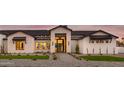Detailed view of the home's facade, highlighting the stone accents, modern windows, and inviting walkway at 6147 E Desert Cove Ave, Scottsdale, AZ 85254