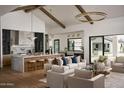 Bright and airy living room open to the kitchen, featuring high ceilings, exposed beams, and stylish furnishings at 6147 E Desert Cove Ave, Scottsdale, AZ 85254