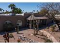 Beautiful home featuring rock landscaping, a stone walkway, and charming desert plants at 6529 E Voltaire Ave, Scottsdale, AZ 85254