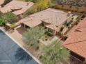 Stunning aerial view of a luxury home featuring a tile roof and desert landscaping at 7201 E Sandia Cir, Mesa, AZ 85207