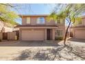 Charming two-story home featuring a two-car garage, arched windows, and mature trees for shade at 7650 E Williams Dr # 1011, Scottsdale, AZ 85255