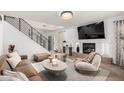 Stylish living room featuring a modern fireplace, sleek furniture, and plenty of natural light at 7650 E Williams Dr # 1011, Scottsdale, AZ 85255