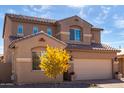Beautiful home featuring a well-kept yard, an attached two-car garage, and a classic facade with a tiled roof at 811 E Gold Dust Way, San Tan Valley, AZ 85143