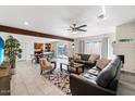 Spacious living room with tile flooring, a ceiling fan, and a cozy seating area at 8209 E Heatherbrae Ave, Scottsdale, AZ 85251