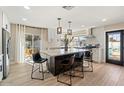 Modern kitchen boasts a large island with pendant lighting and a seamless connection to the outdoor patio at 8213 E Fairmount Ave, Scottsdale, AZ 85251