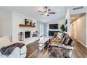 Comfortable living room featuring a fireplace, a ceiling fan, and a cozy seating arrangement at 8227 N 15Th Pl, Phoenix, AZ 85020