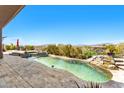 Private pool features a cascading waterfall, spa, and travertine tile deck, offering relaxation and scenic views at 9630 E Preserve Way, Scottsdale, AZ 85262