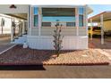 The exterior of this cozy home features rock landscaping and a charming decorative lawn sculpture at 9736 E Main St # 43, Mesa, AZ 85207