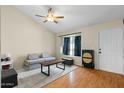 Comfortable living room with a ceiling fan and a window providing natural light at 9853 E Birchwood Ave, Mesa, AZ 85208