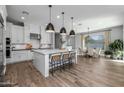 Bright kitchen featuring a large island, modern pendant lights, and an adjacent dining area at 10511 E Diffraction Ave, Mesa, AZ 85212