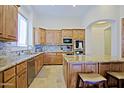 Well-appointed kitchen with custom cabinetry, granite countertops, and stainless steel appliances at 13627 E Monument Dr, Scottsdale, AZ 85262