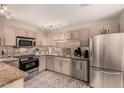 Well-lit kitchen featuring stainless steel appliances, granite countertops, and neutral-toned cabinets at 15050 N Thompson Peak Pkwy # 1035, Scottsdale, AZ 85260