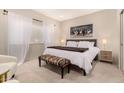 Cozy bedroom featuring a large bed, soft lighting, neutral tones, and sheer curtains at 15050 N Thompson Peak Pkwy # 1035, Scottsdale, AZ 85260