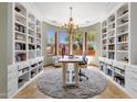 Home office with built-in bookshelves, a chandelier, and windows providing natural light at 15106 E Miravista --, Fountain Hills, AZ 85268