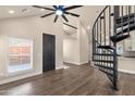 Bright living room with a unique spiral staircase, modern ceiling fan, and hardwood floors at 1533 W Culver St, Phoenix, AZ 85007