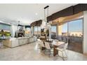 Open-concept living space with a fireplace, dining area, and balcony access with scenic views at 15802 N 71St St # 754, Scottsdale, AZ 85254