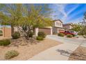 Beautiful two-story home with desert landscaping, a two-car garage, and a well-maintained front yard at 16658 W Mescal St, Surprise, AZ 85388