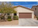 Charming single-story home with a two-car garage, desert landscaping, and a well-maintained front yard at 16658 W Mescal St, Surprise, AZ 85388